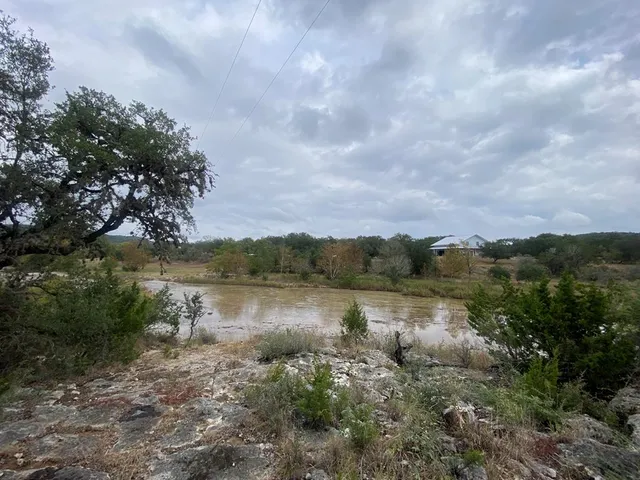 a view of a lake with houses in the back