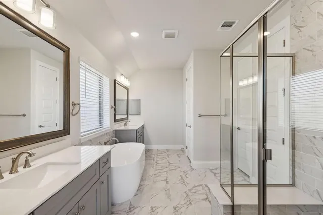 a spacious bathroom with a sink mirror and a shower