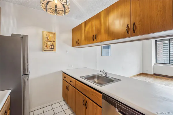 a kitchen with stainless steel appliances a sink and a refrigerator