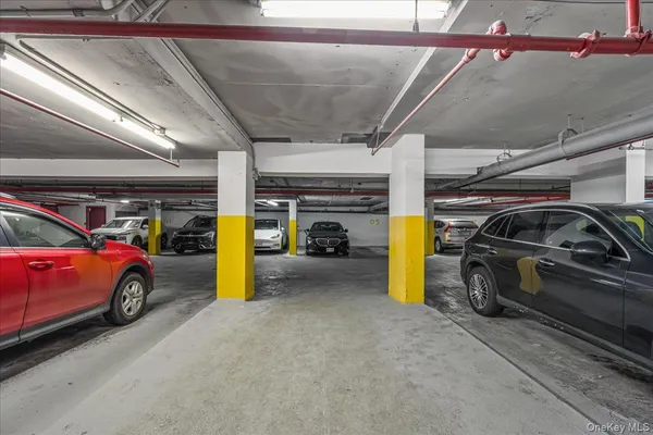 a view of parking garage with cars