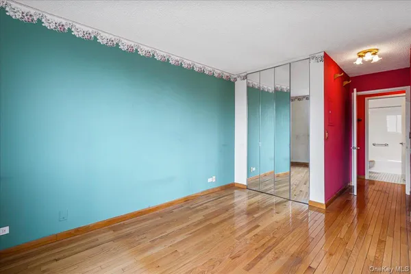 a view of a room with wooden floor