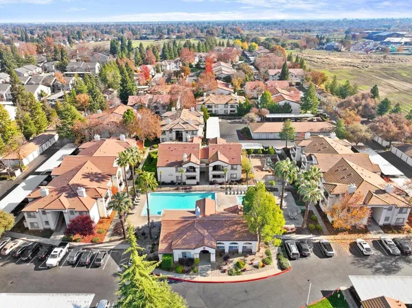 an aerial view of residential houses with outdoor space