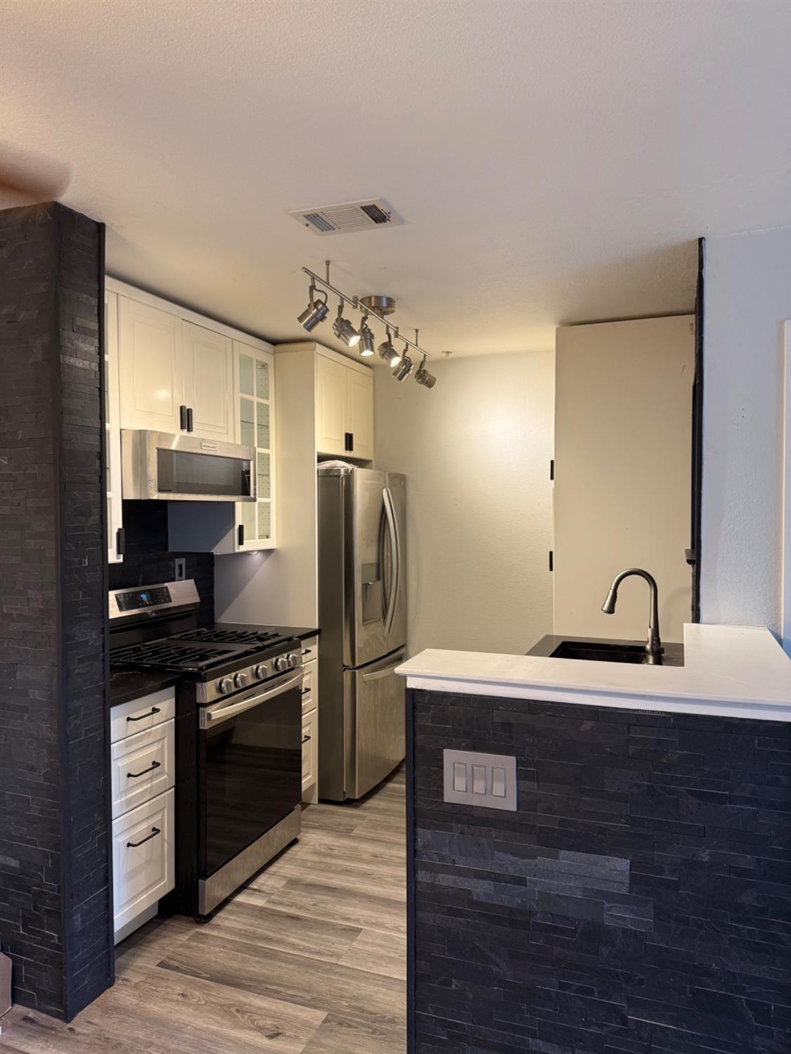 8020 Walerga Road, Unit 1093 Antelope, CA 95843 - Photo 6 of 13 a kitchen with a refrigerator and a sink