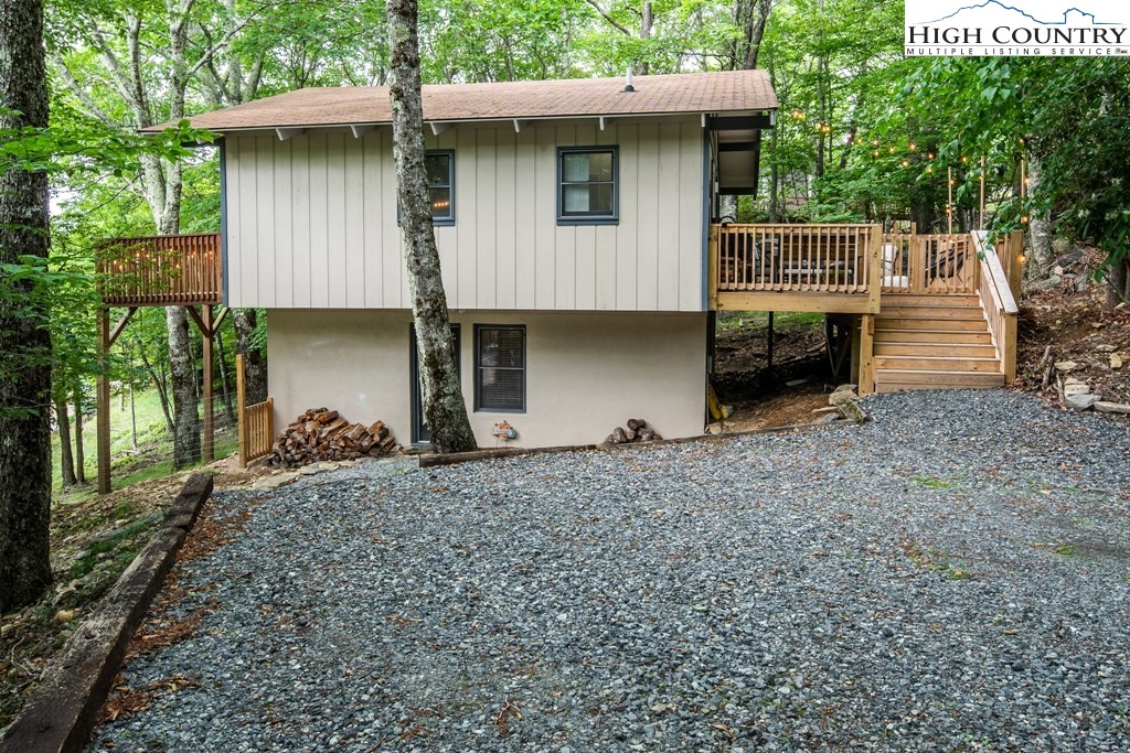 228 Pine Ridge Road Beech Mountain, NC 28604 - Photo 3 of 33 a view of a house with a yard and large tree