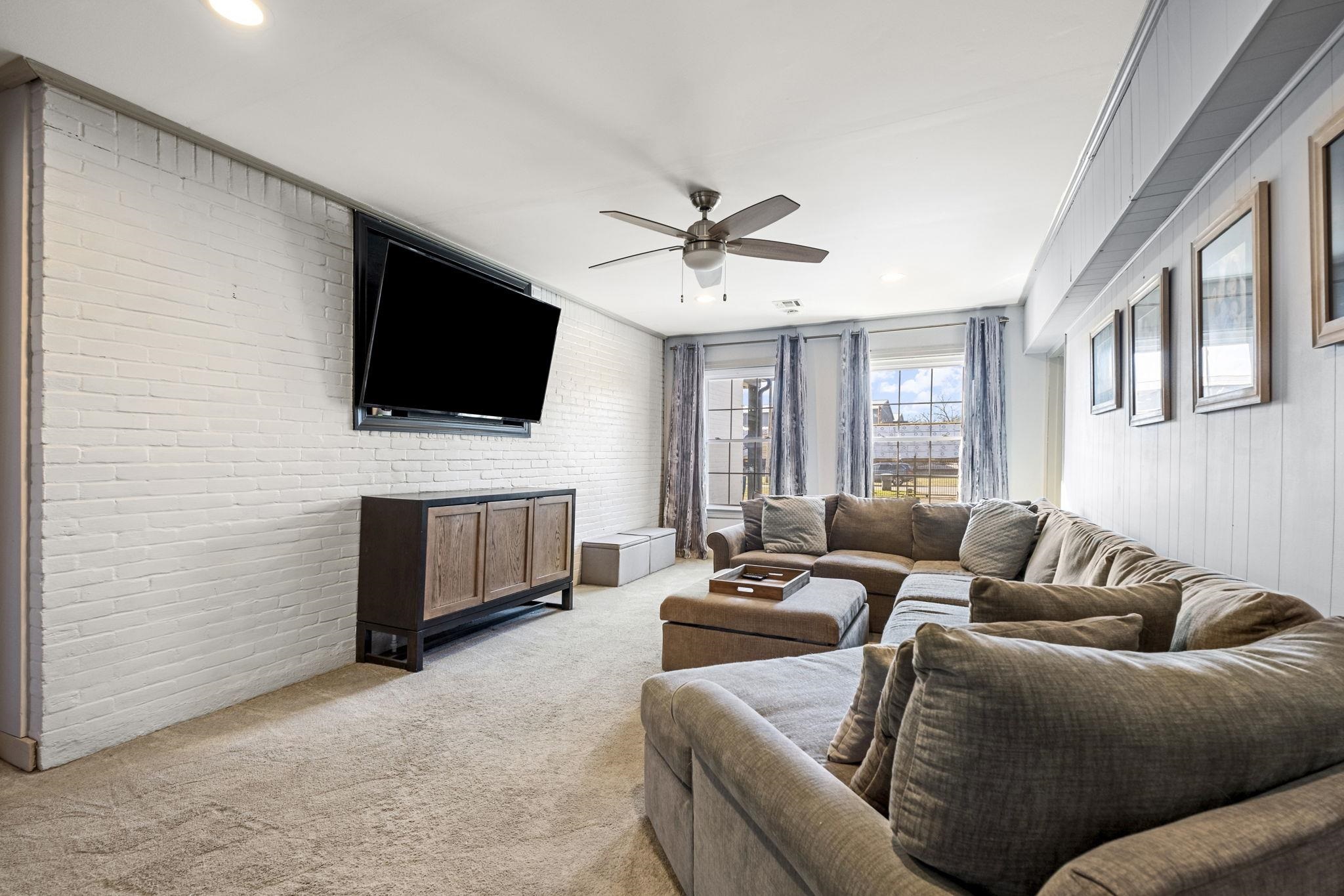 4120 Village Road Memphis, TN 38117 - Photo 11 of 28 Living area featuring brick wall, ceiling fan, light carpet, and recessed lighting