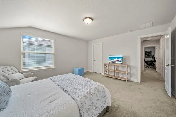 a bedroom with a bed and a window