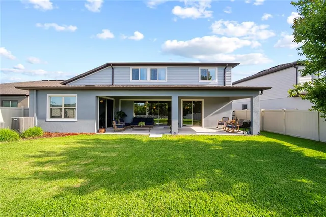 a view of a house with a yard and porch