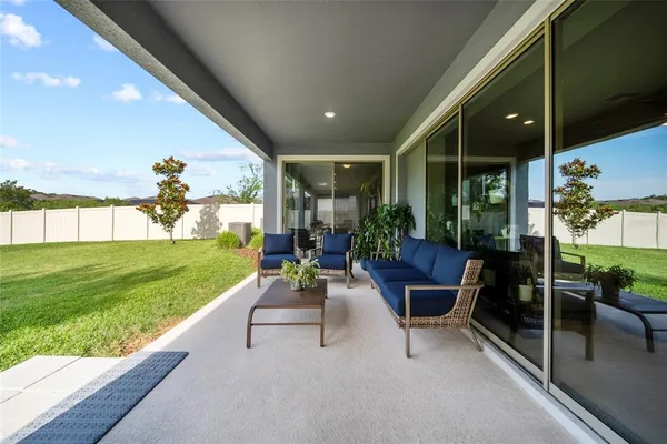 a view of a house with backyard and a sitting area