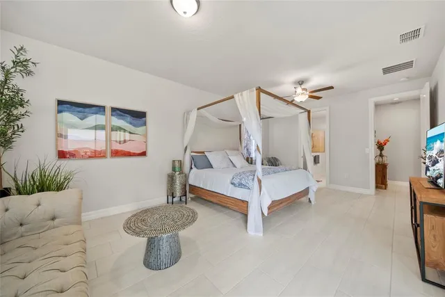 a bedroom with a bed and a chandelier