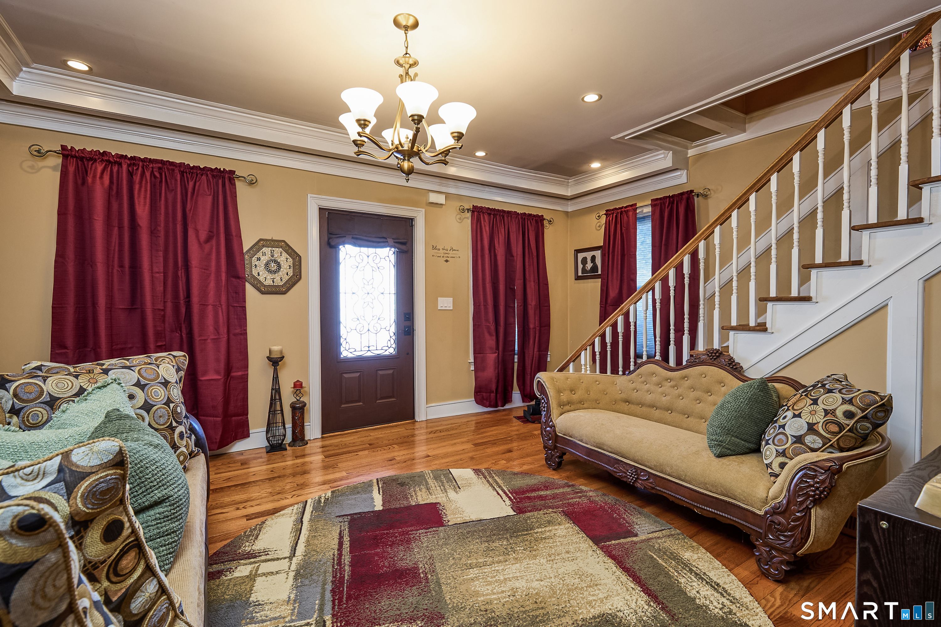 a living room with furniture and a chandelier