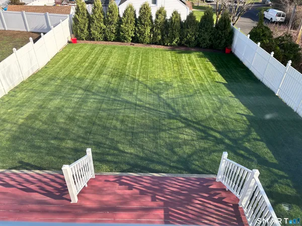 a view of a balcony with a yard