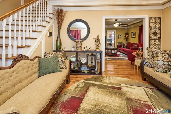 a living room with furniture a mirror and a table