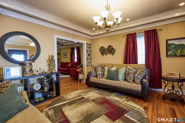 a living room with furniture and a chandelier