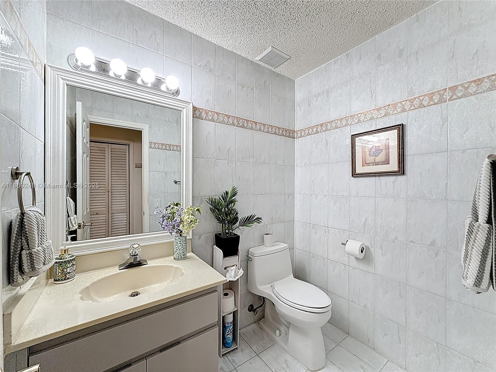 10462 Southwest 121st Street Miami, FL 33176 - Photo 11 of 35 a bathroom with a sink a toilet and shower