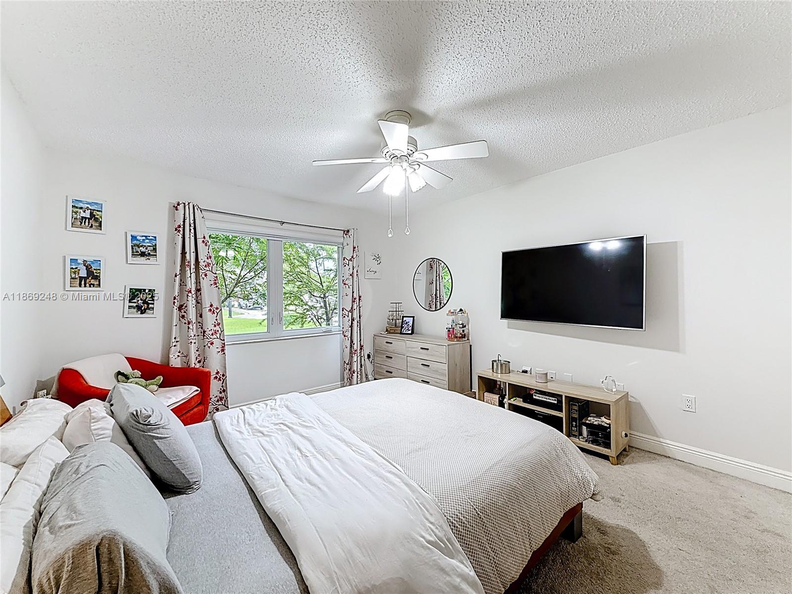 10462 Southwest 121st Street Miami, FL 33176 - Photo 18 of 35 a bedroom with a bed and a flat screen tv