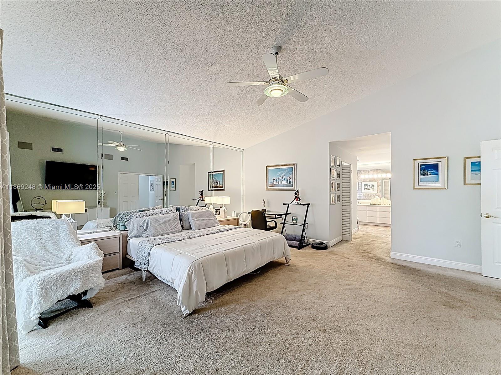 10462 Southwest 121st Street Miami, FL 33176 - Photo 23 of 35 a spacious bedroom with a bed and a flat screen tv