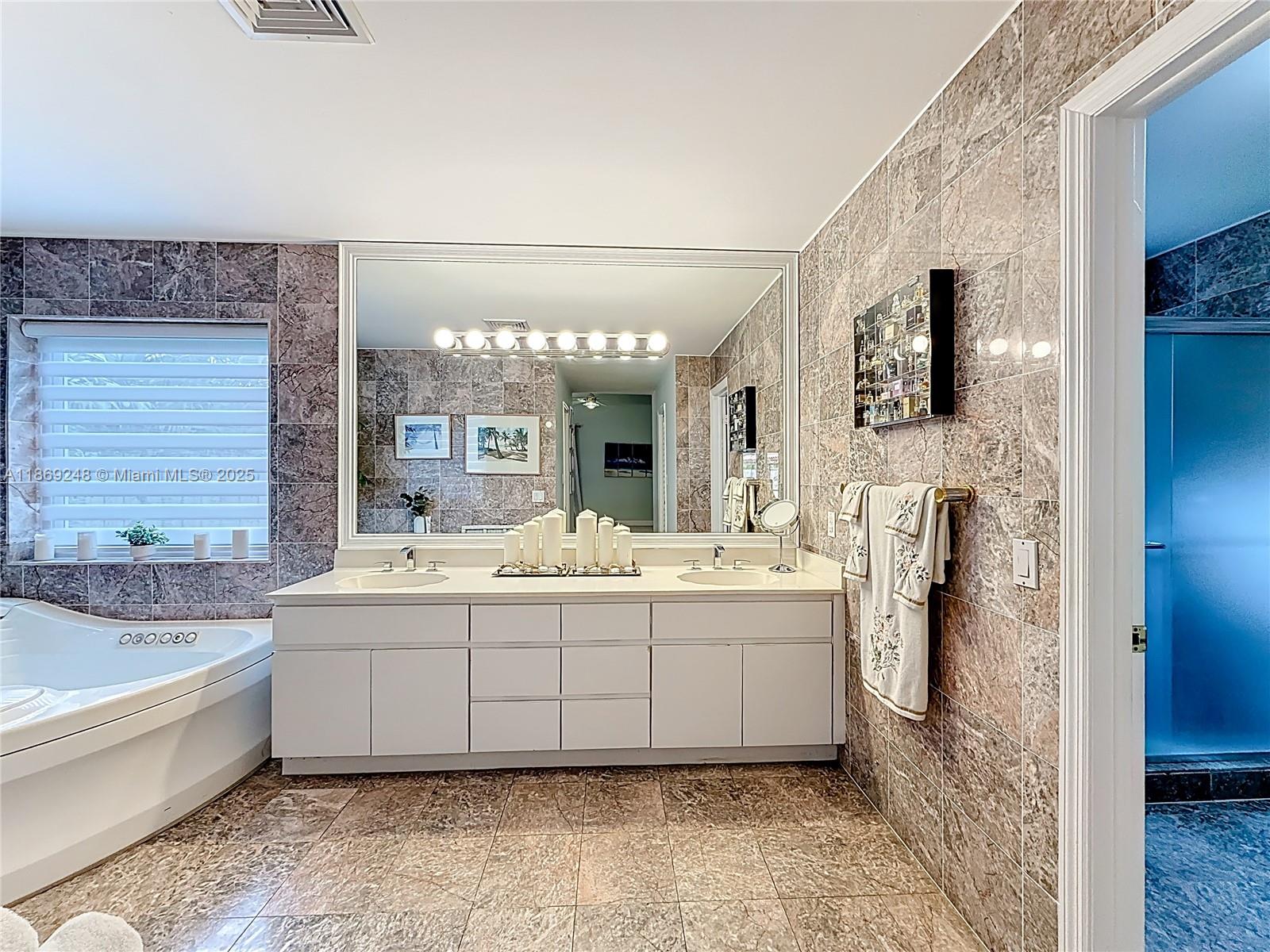 10462 Southwest 121st Street Miami, FL 33176 - Photo 25 of 35 a spacious bathroom with a tub sink and mirror