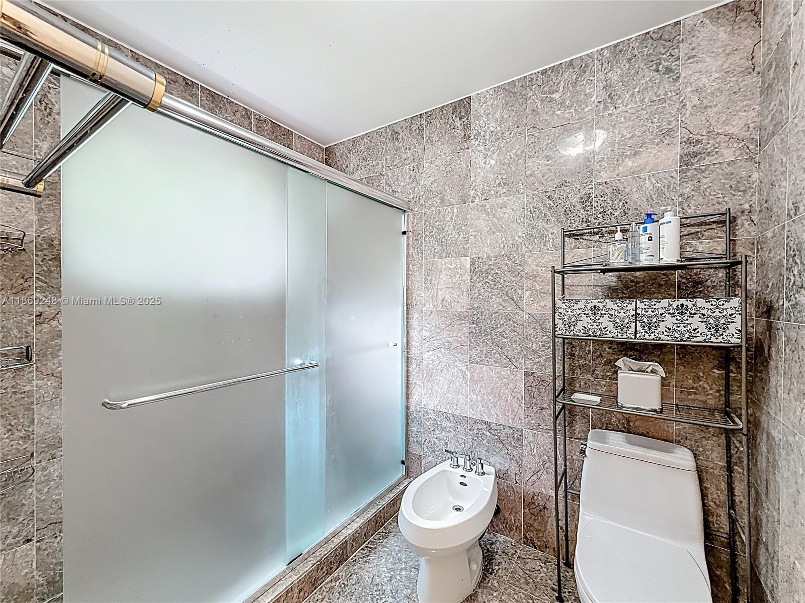 10462 Southwest 121st Street Miami, FL 33176 - Photo 27 of 35 a bathroom with a granite countertop sink toilet and shower