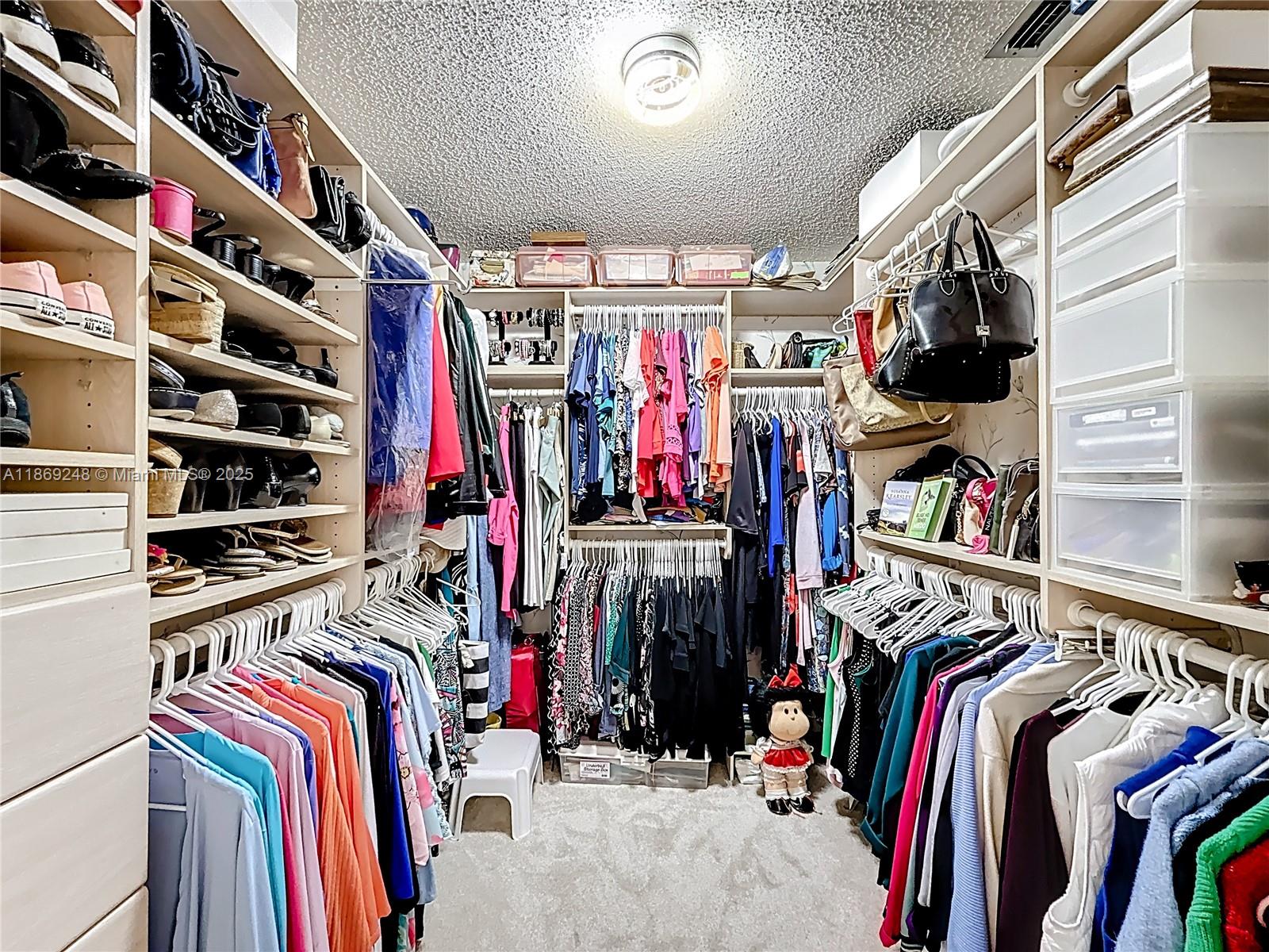 10462 Southwest 121st Street Miami, FL 33176 - Photo 28 of 35 a view of walk in closet with clothes