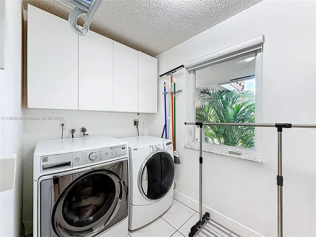 a view of a hallway with washer and dryer