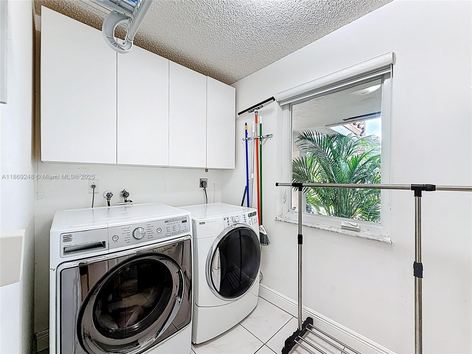10462 Southwest 121st Street Miami, FL 33176 - Photo 29 of 35 a view of a hallway with washer and dryer