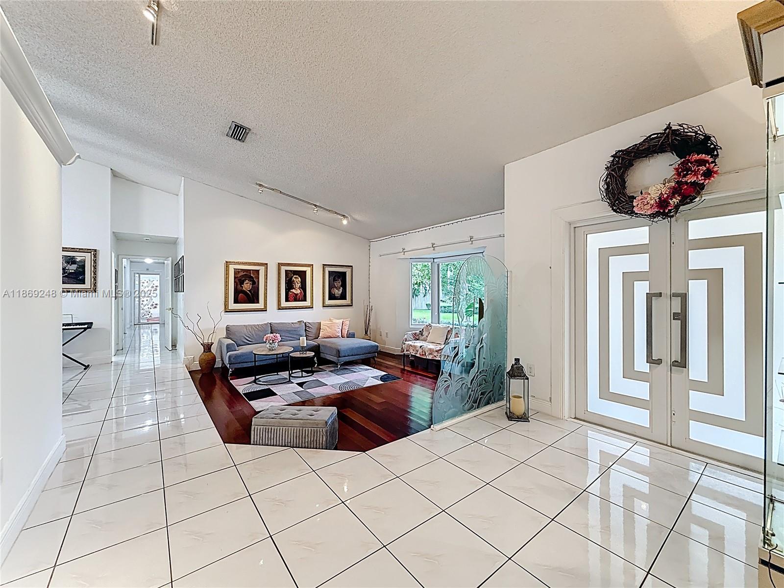 10462 Southwest 121st Street Miami, FL 33176 - Photo 3 of 35 a living room with furniture and a large window