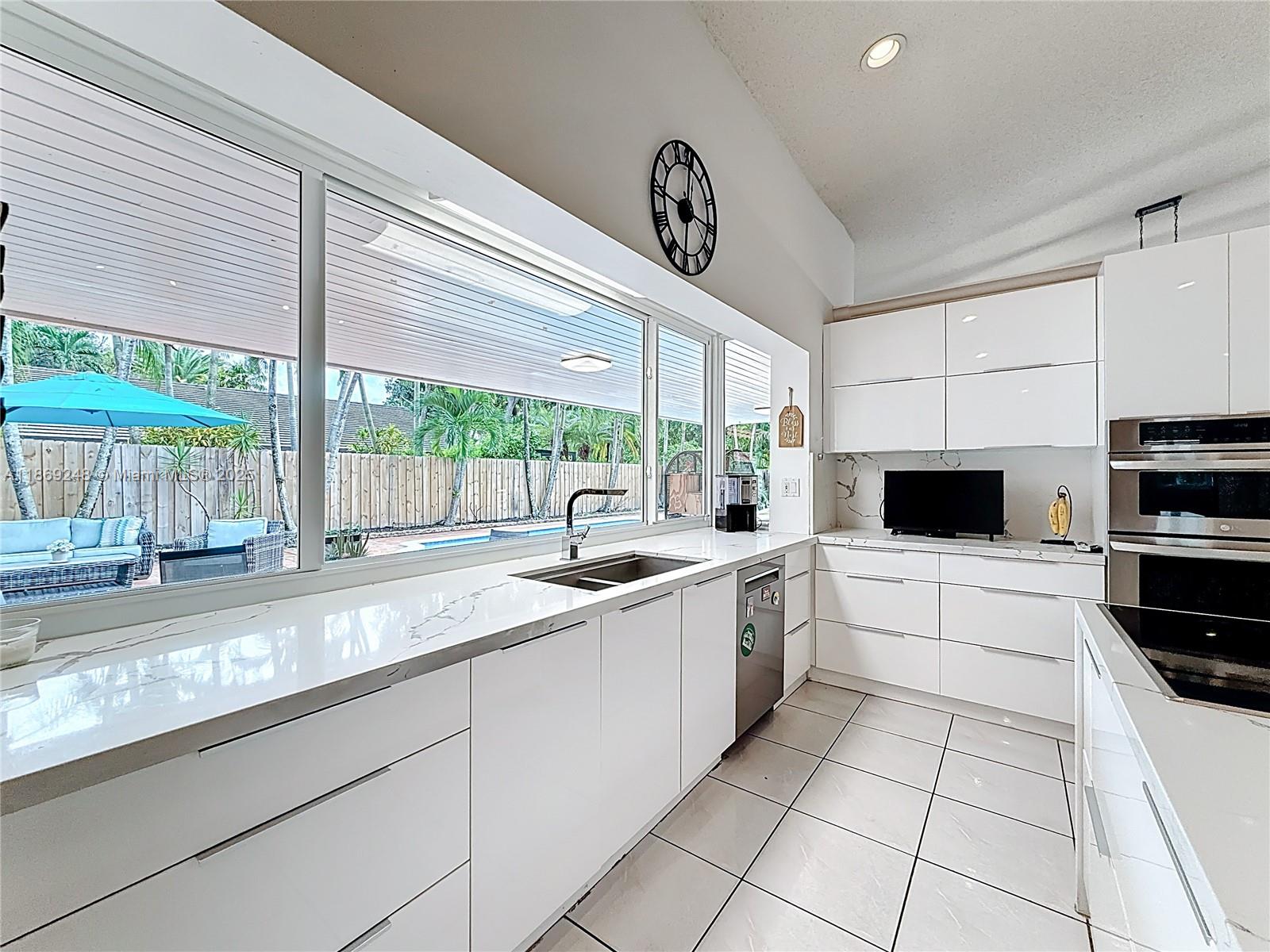 10462 Southwest 121st Street Miami, FL 33176 - Photo 7 of 35 a kitchen with a sink and a stove