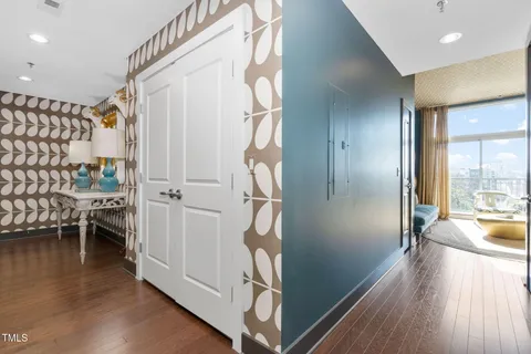 a view of hallway with furniture and wooden floor