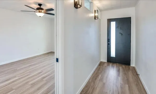 wooden floor in an empty room with a window