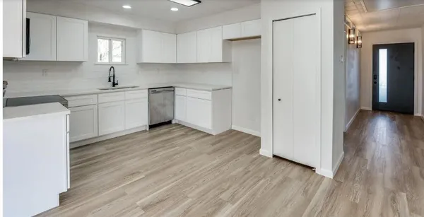 a kitchen with a refrigerator a sink and cabinets