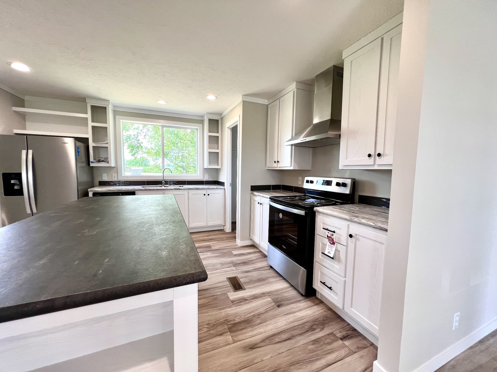 1081 McAfee Road Morrison, TN 37357 - Photo 13 of 39 a kitchen with stainless steel appliances granite countertop a stove a sink and a refrigerator