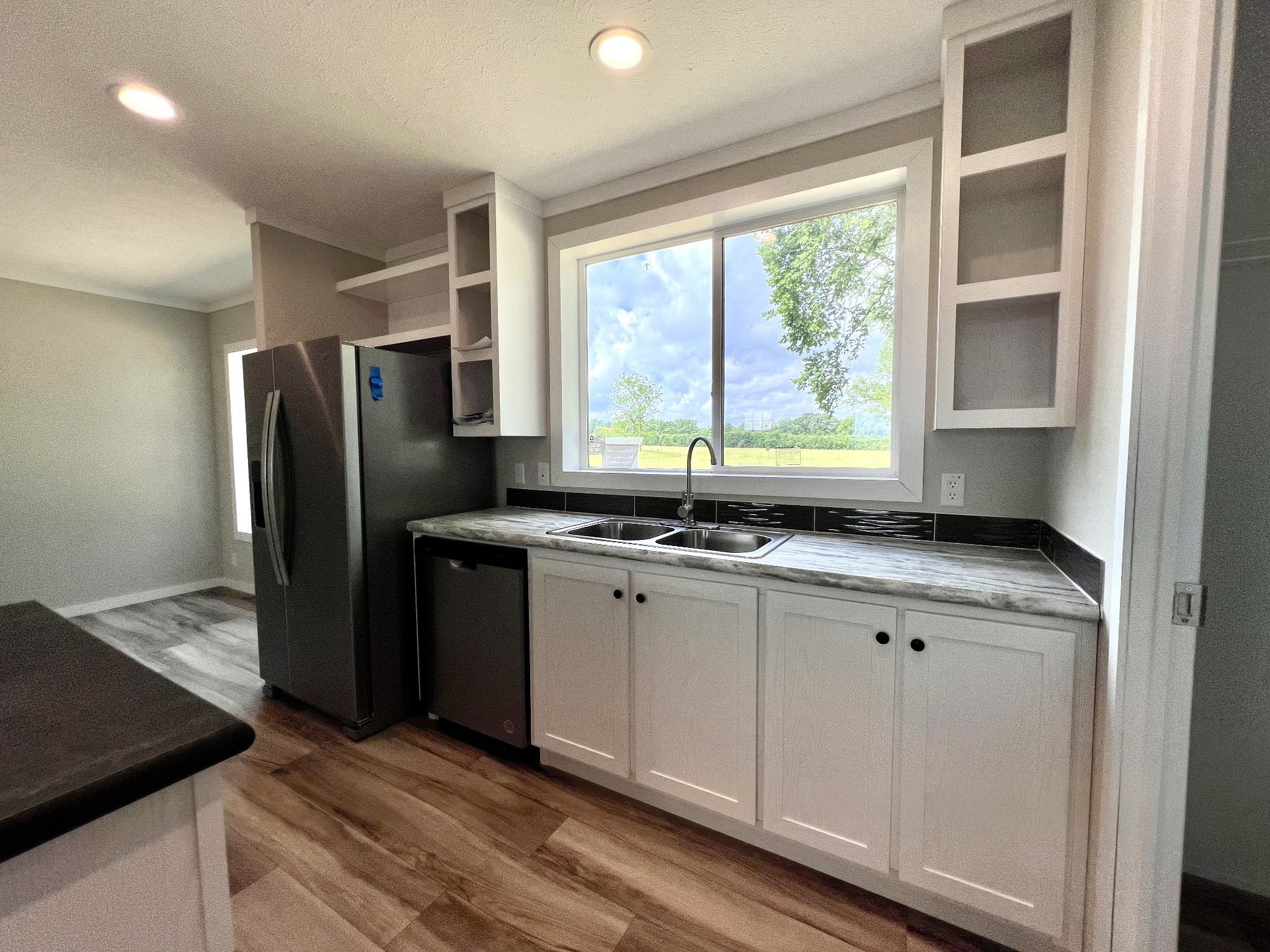 1081 McAfee Road Morrison, TN 37357 - Photo 14 of 39 a kitchen with granite countertop a sink and a refrigerator