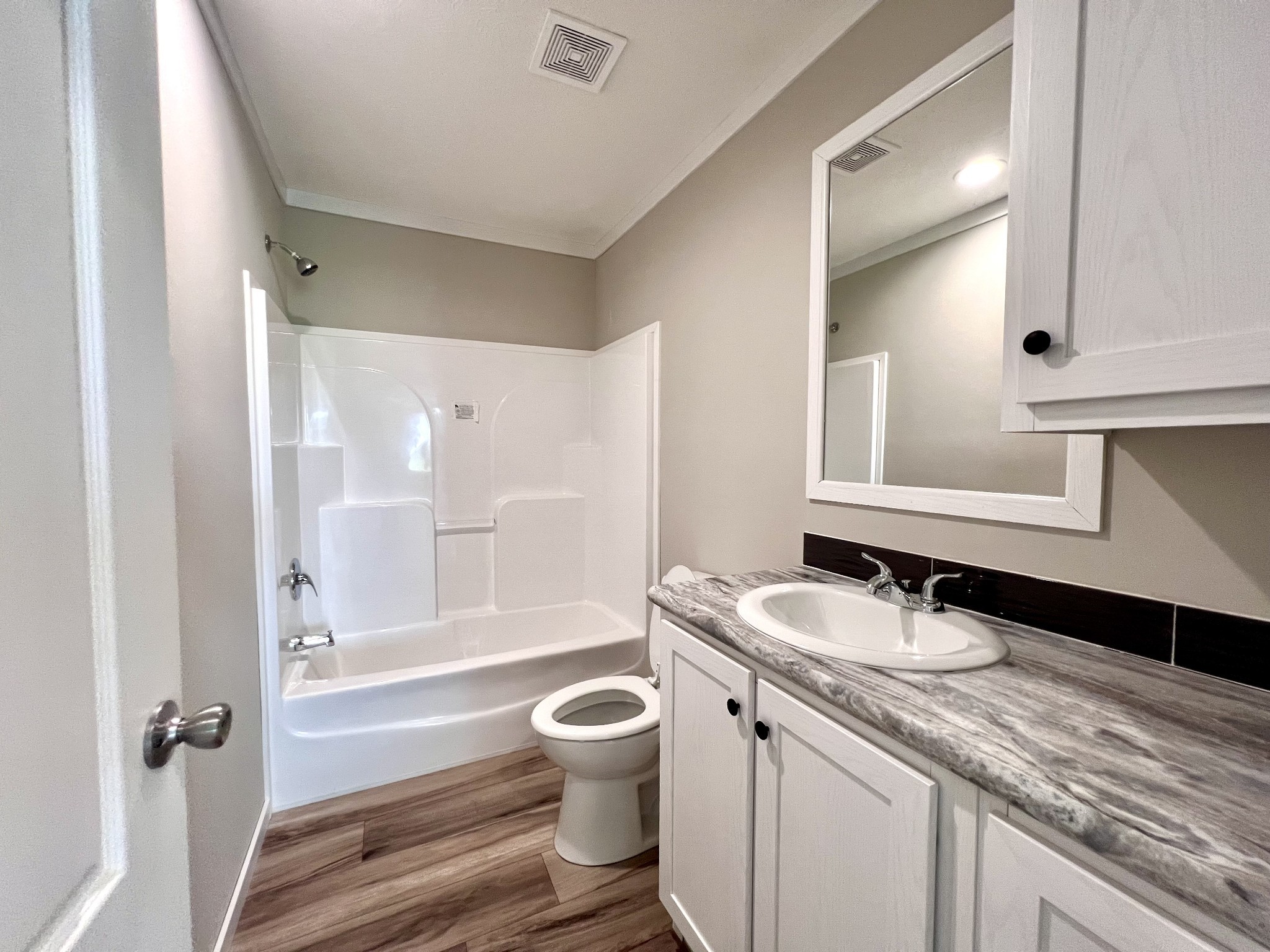 1081 McAfee Road Morrison, TN 37357 - Photo 28 of 39 a bathroom with a granite countertop sink toilet a mirror and shower