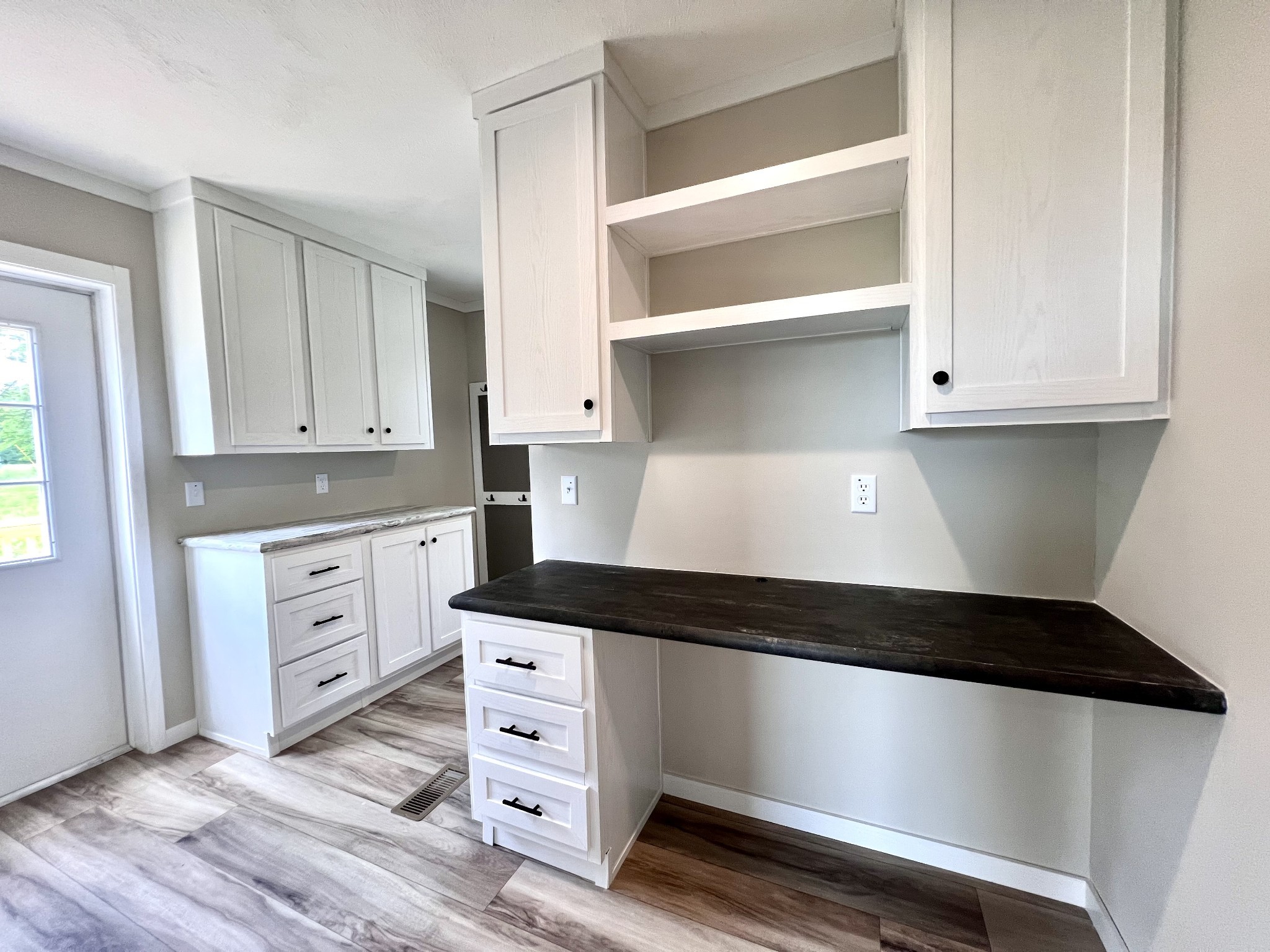 1081 McAfee Road Morrison, TN 37357 - Photo 31 of 39 a kitchen with white cabinets and black appliances