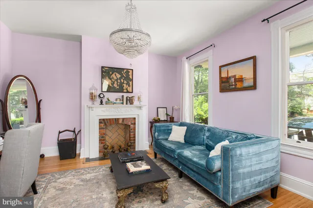 a dining room with furniture a chandelier and wooden floor