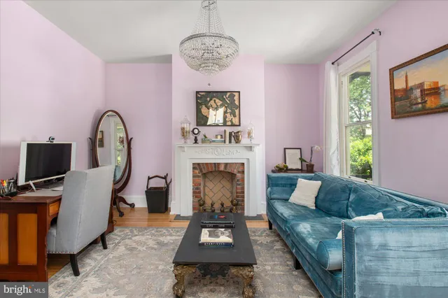 a dining room with furniture window and wooden floor