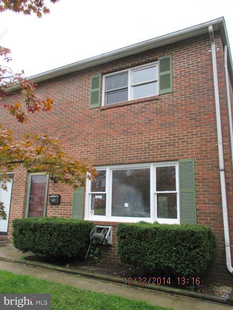 1045 Grovehill Road Baltimore, MD 21227 - Photo 1 of 27 front view of a brick house with a yard