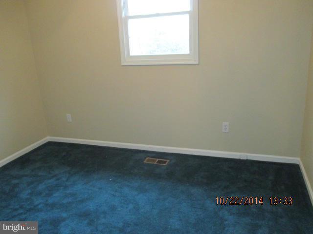 1045 Grovehill Road Baltimore, MD 21227 - Photo 13 of 27 an empty room with a window