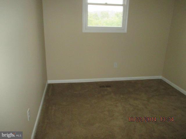 1045 Grovehill Road Baltimore, MD 21227 - Photo 15 of 27 an empty room with a window