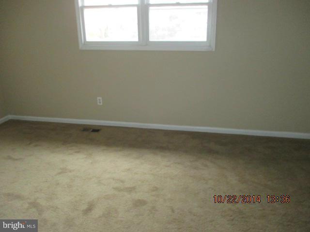 1045 Grovehill Road Baltimore, MD 21227 - Photo 17 of 27 an empty room with a window