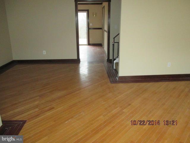1045 Grovehill Road Baltimore, MD 21227 - Photo 3 of 27 a view of a hallway with wooden floor