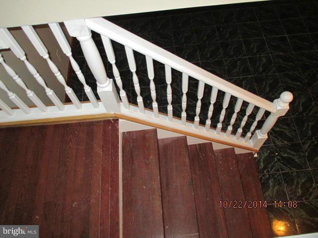 1045 Grovehill Road Baltimore, MD 21227 - Photo 21 of 27 a view of staircase with railing and white walls