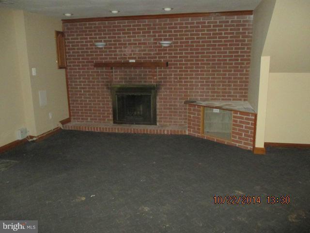 1045 Grovehill Road Baltimore, MD 21227 - Photo 24 of 27 a view of empty room with a fireplace