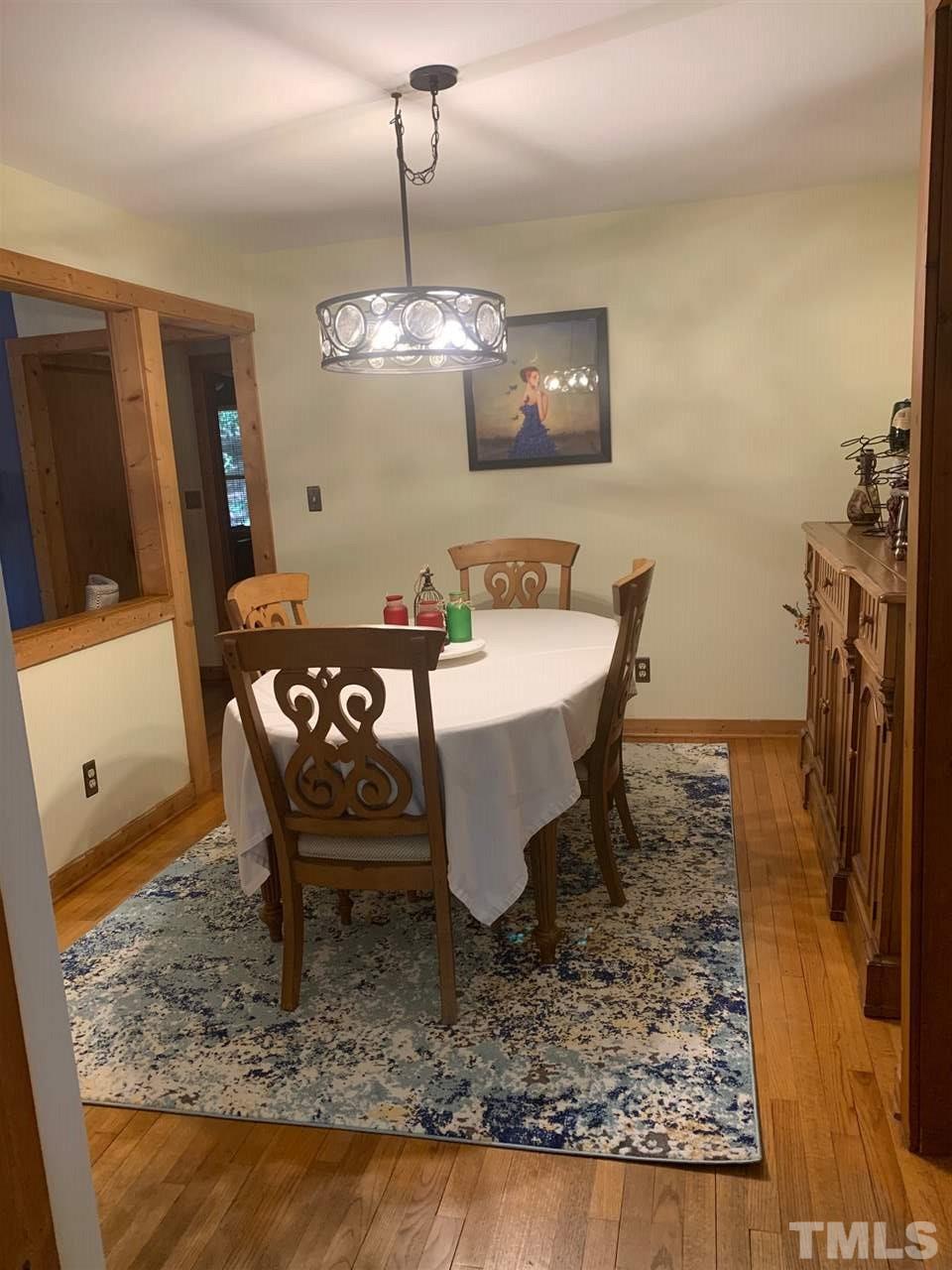 11940 Straight A Way Lane Raleigh, NC 27613 - Photo 3 of 4 a dining room with a table chairs and kitchen view