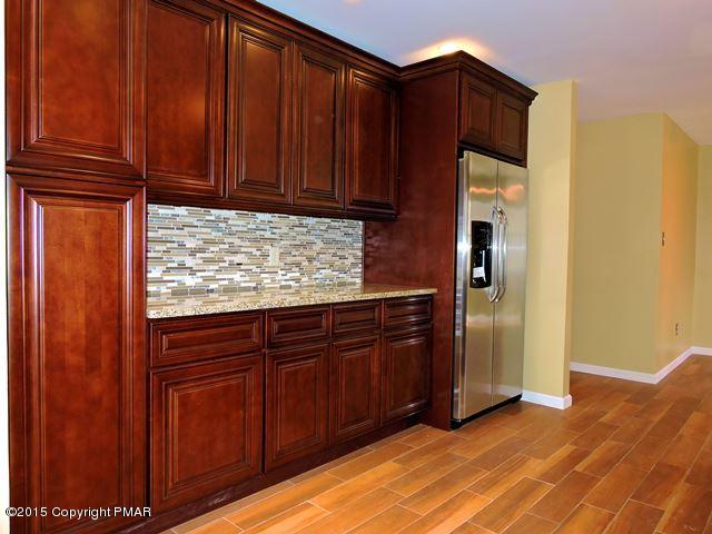 248 Pin Oak Road Stroudsburg, PA 18360 - Photo 15 of 33 a kitchen with granite countertop wooden cabinets and granite counter tops