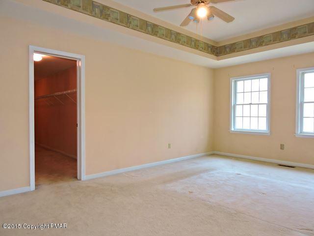 248 Pin Oak Road Stroudsburg, PA 18360 - Photo 17 of 33 an empty room with a chandelier fan and windows