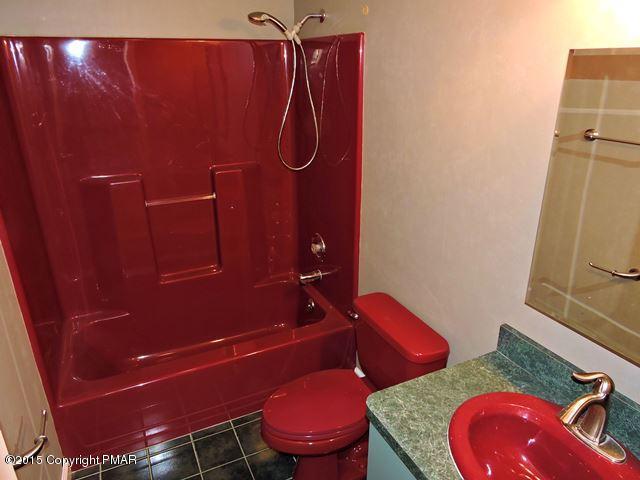 248 Pin Oak Road Stroudsburg, PA 18360 - Photo 24 of 33 a bathroom with a granite countertop toilet and a sink