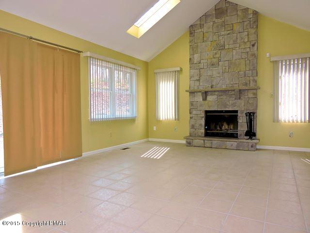248 Pin Oak Road Stroudsburg, PA 18360 - Photo 7 of 33 an empty room with windows and fireplace