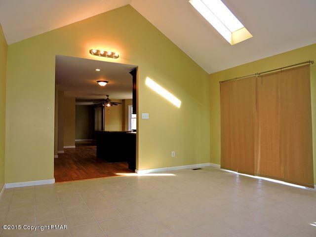 248 Pin Oak Road Stroudsburg, PA 18360 - Photo 8 of 33 an empty room with wooden floor and windows
