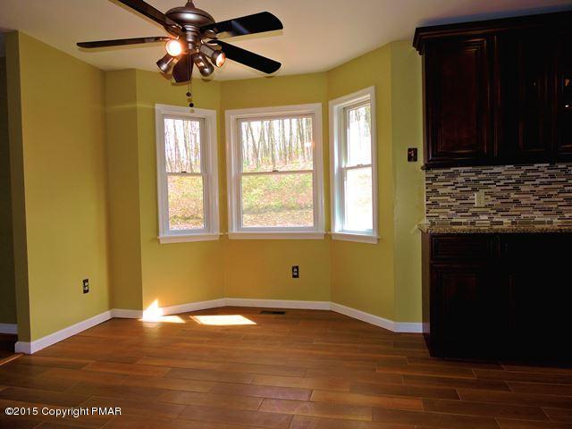 248 Pin Oak Road Stroudsburg, PA 18360 - Photo 10 of 33 a view of empty room with wooden floor and fan
